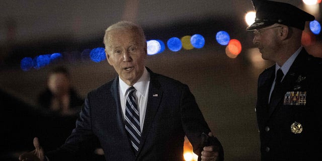 President Biden responds to a question regarding the U.S. Senate runoff election in Georgia, after disembarking Air Force One at Joint Base Andrews in Maryland on Dec. 6, 2022. 