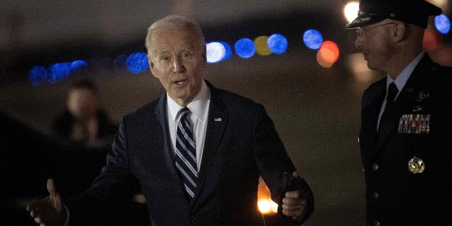 US President Joe Biden responds to a question regarding the US Senate runoff election in Georgia, after disembarking Air Force One at Joint Base Andrews in Maryland on December 6, 2022.