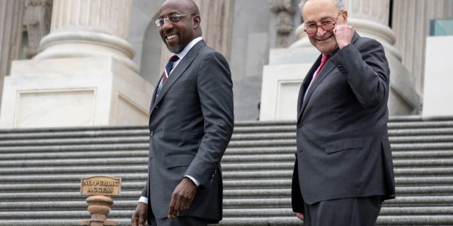 Senate Majority Leader Chuck Schumer, D-N.Y., and Sen. Raphael Warnock, D-Ga., walk up the Senate steps as Warnock returns to Washington after winning the Georgia runoff election Dec. 7, 2022, in Washington, D.C.