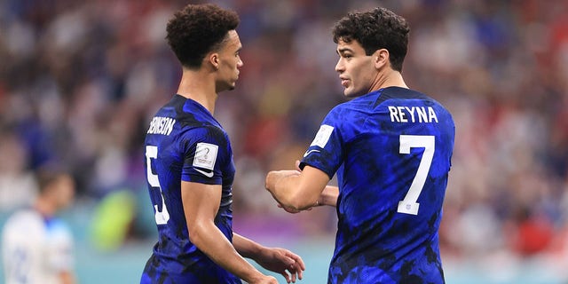 Giovanni Reyna of the United States talks with teammate Antoine Robinson during the FIFA World Cup Qatar 2022 Group B match against England at Al Bayt Stadium on November 25, 2022 in Al Khor, Qatar.