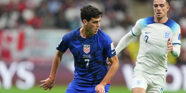 Gio Reyna of the United States, left, turns with the ball during a FIFA World Cup Qatar 2022 Group B match against England at Al Bayt Stadium Nov. 25, 2022, in Al Khor, Qatar.