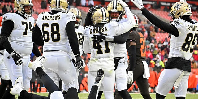 Alvin Kamara #41 of the New Orleans Saints celebrates a touchdown with Andy Dalton #14 during the third quarter in the game against the Cleveland Browns at FirstEnergy Stadium on December 24, 2022 in Cleveland, Ohio. 