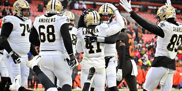 Alvin Kamara #41 of the New Orleans Saints celebrates a touchdown with Andy Dalton #14 during the third quarter of the game against the Cleveland Browns at FirstEnergy Stadium on December 24, 2022 in Cleveland, Ohio.