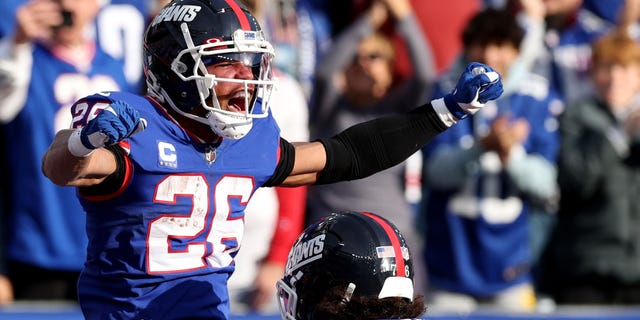 Saquon Barkley of the New York Giants celebrates after scoring a touchdown in the second quarter of the game against the Washington Commanders at MetLife Stadium in East Rutherford, NJ.  December 4, 2022