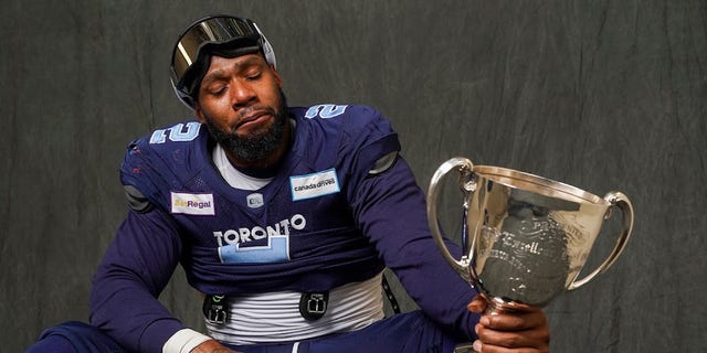 Toronto Argonauts defensive end Shawn Oakman gets emotional while holding the Canadian Football League's Grey Cup. 