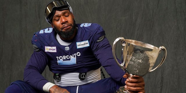 Toronto Argonauts defensive end Shawn Oakman gets emotional while holding the Canadian Football League's Grey Cup. 