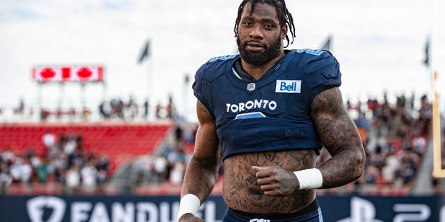 Toronto Argonauts defensive end Shawn Oakman runs onto the field.