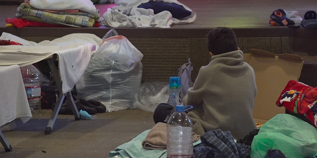 A young boy sits in the chapel of the Rescue Mission of El Paso on Dec. 13, 2022. The nonprofit is using every inch of space in their building to house some of the many migrants crossing the border.