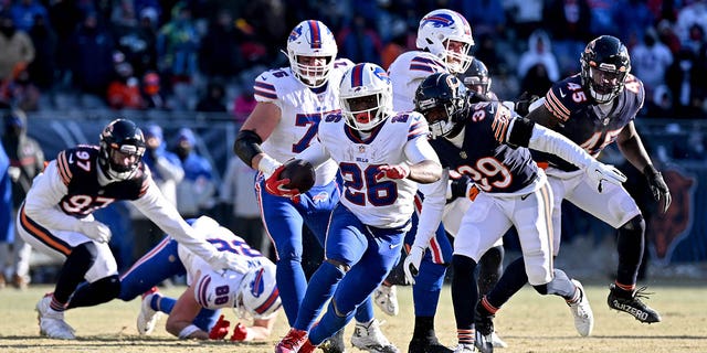 Devin Singletary #26 of the Buffalo Bills runs for a touchdown during the third quarter of a game against the Chicago Bears at Soldier Field on December 24, 2022 in Chicago, Illinois.