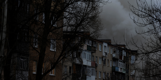 Smoke rises from apartment buildings damaged from missile strikes, as Russia's attack on Ukraine continues, during intense shelling on Christmas Day at the frontline in Bakhmut, Ukraine.