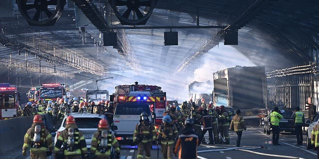 Firefighters work to extinguish a fire on a highway in Gwacheon, South Korea, on Dec. 29, 2022. The fire killed five people and injured 37 others.