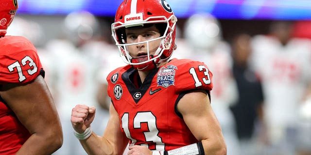 Stetson Bennett #13 of the Georgia Bulldogs reacts after a touchdown during the first half against the Ohio State Buckeyes in the Chick-fil-A Peach Bowl at Mercedes-Benz Stadium on December 31, 2022 in Atlanta, Georgia.