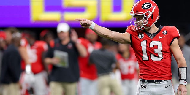 Georgia Bulldogs' Stetson Bennett celebrates after throwing a touchdown pass against the LSU Tigers during the second quarter of the SEC Championship at Mercedes-Benz Stadium on December 3, 2022 in Atlanta, Georgia.