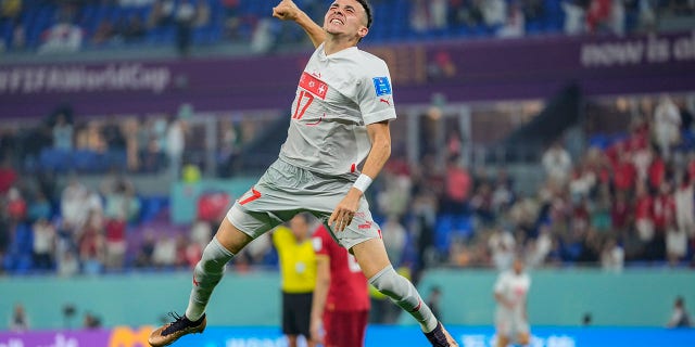 Switzerland's Ruben Vargas celebrates after his teammate Remo Freuler scored his side's third goal during a World Cup Group G soccer match against Serbia at the Stadium 974 in Doha, Qatar, Friday, Dec. 2, 2022.Â