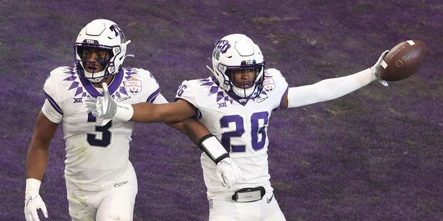 Bud Clark #26 of the TCU Horned Frogs celebrates after returning an interception for a touchdown during the first quarter against the Michigan Wolverines in the Vrbo Fiesta Bowl at State Farm Stadium on December 31, 2022, in Glendale, Arizona.