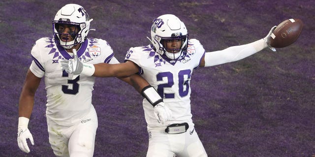 Bud Clark #26 of the TCU Horned Frogs celebrates after returning an interception for a touchdown during the first quarter against the Michigan Wolverines at the Vrbo Fiesta Bowl at State Farm Stadium on December 31, 2022 in Glendale, Arizona.