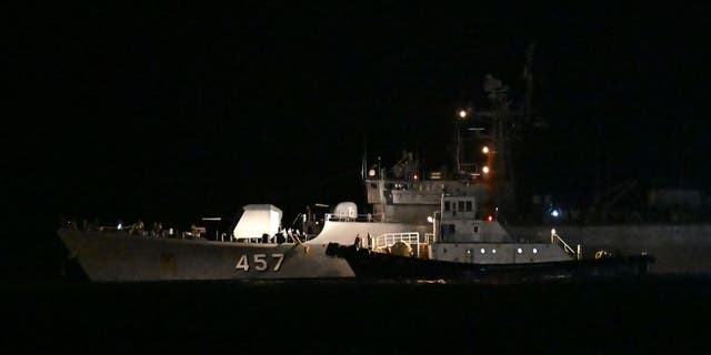 A rescue boat attaches itself to a navy vessel at Bang Saphan Pier in Prachuap Khiri Khan district, on December 19, 2022. LILLIAN SUWANRUMPHA/AFP via Getty Images)