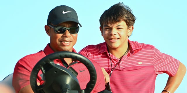 Tiger Woods and his son, Charlie, watch Justin Thomas during the final round of the Hero World Challenge at Albany on December 4, 2022, in Nassau, New Providence, Bahamas.