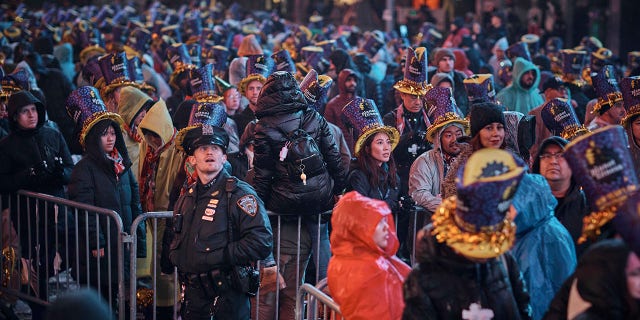 Revelers gather under the rain during the New Year's Eve celebrations in Times Square on Saturday, Dec. 31, 2022, in New York.