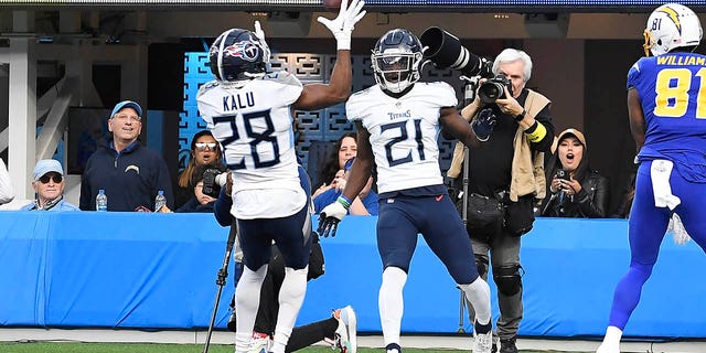Roger McCreary #21 of the Tennessee Titans tips a pass intended for Mike Williams #81 of the Los Angeles Chargers to Joshua Kalu #28 of the Tennessee Titans for an interception during the second quarter at SoFi Stadium on December 18, 2022 in Inglewood, California.