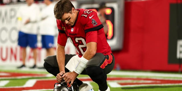 Tom Brady #12 of the Tampa Bay Buccaneers kneels in the end zone prior to an NFL football game against the New Orleans Saints at Raymond James Stadium on December 5, 2022 in Tampa, Florida.