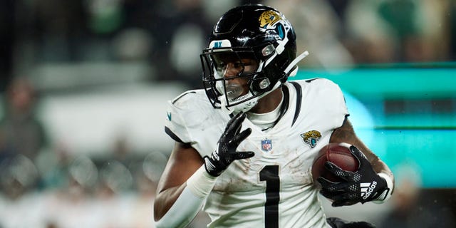 Jacksonville Jaguars No. 1 Travis Etienne Jr. carries the ball against the New York Jets during the first half at MetLife Stadium on December 22, 2022 in East Rutherford, New Jersey.
