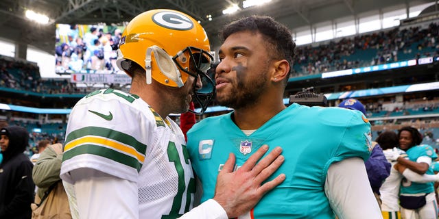 Aaron Rodgers, left, of the Green Bay Packers hugs Tua Tagovailoa of the Miami Dolphins on the field after the game at Hard Rock Stadium on December 25, 2022, in Miami Gardens, Florida.