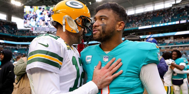 Aaron Rodgers of the Green Bay Packers hugs Tua Tagovailoa of the Dolphins on the field after the game at Hard Rock Stadium on Dec. 25, 2022, in Miami Gardens, Florida.