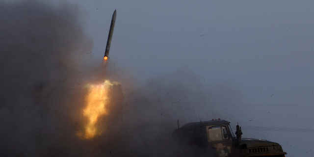 A Ukrainian BM-21 Grad multiple rocket launcher fires a rocket, as Russia's attack on Ukraine continues, during intense shelling on Christmas Day at the frontline in Bakhmut, Ukraine, December 25, 2022.