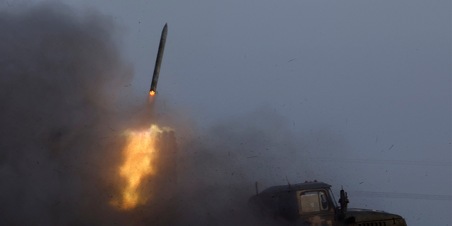 A Ukrainian BM-21 Grad multiple rocket launcher fires a rocket, as Russia's attack on Ukraine continues, during intense shelling on Christmas Day at the frontline in Bakhmut, Ukraine, December 25, 2022.