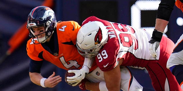 Arizona Cardinals defensive end J.J. Watt (99) sacks Denver Broncos quarterback Brett Rypien (4) during the first half of an NFL football game, Sunday, Dec. 18, 2022, in Denver.
