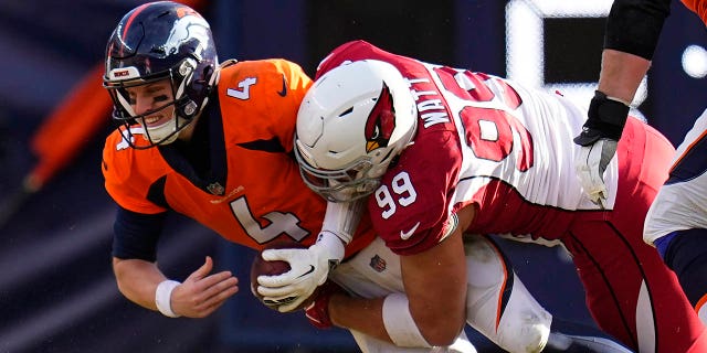 Arizona Cardinals defensive end J.J. Watt (99) sacks Denver Broncos quarterback Brett Rypien (4) during the first half of an NFL football game, Sunday, Dec. 18, 2022, in Denver.