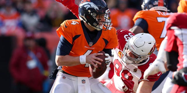 J.J. Watt #99 of the Arizona Cardinals sacks Brett Rypien #4 of the Denver Broncos during the first half at Empower Field At Mile High on December 18, 2022 in Denver, Colorado.