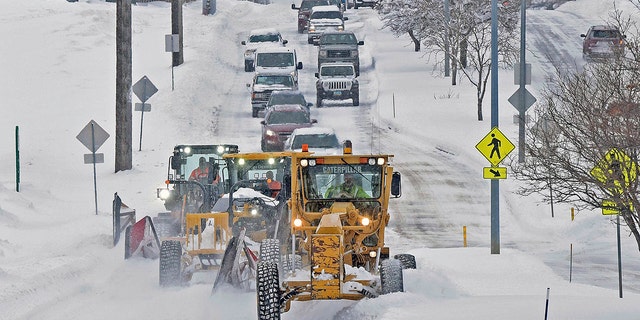 As parts of North Dakota saw snow on Friday, a trio of plows cleared Century Avenue near Jaycee Park in Bismarck. 
