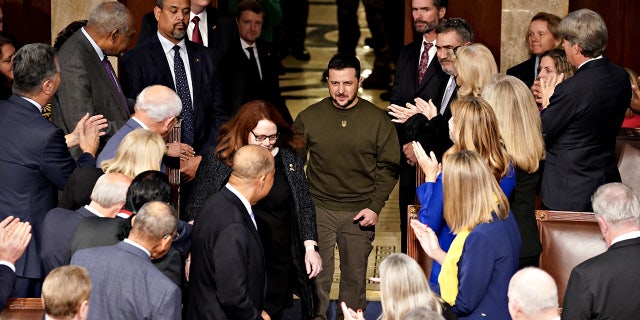 Ukranian President Volodymyr Zelenskyy, center, arrives to speak during a joint meeting of Congress at the U.S. Capitol on Dec. 21, 2022.