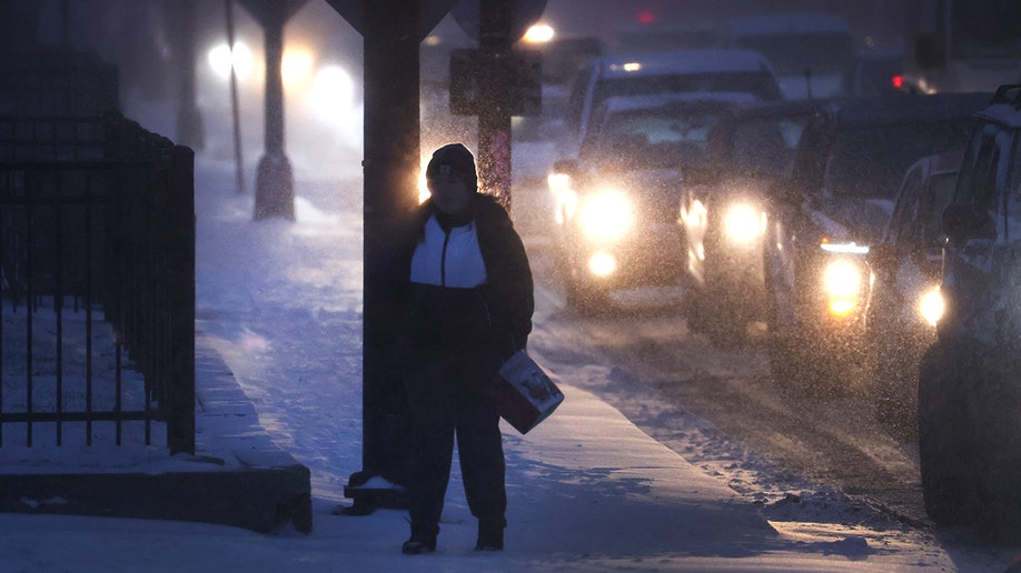 Woman walks through the snow in Chicago.