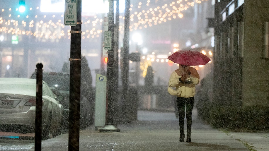 Woman with umbrella walking down street in Cincinnati, Ohio.