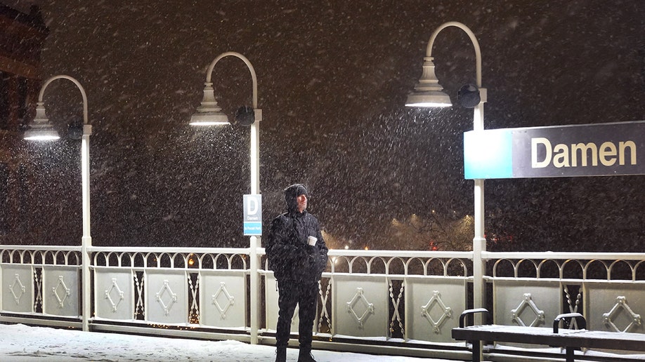 Man waits for the L train Chicago.