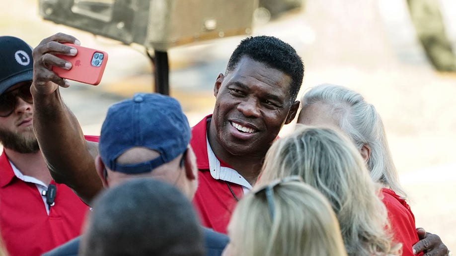 Herschel Walker smiles with supporters