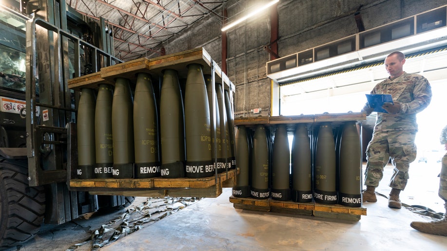 U.S. Air Force member stands with shells heading to Ukraine