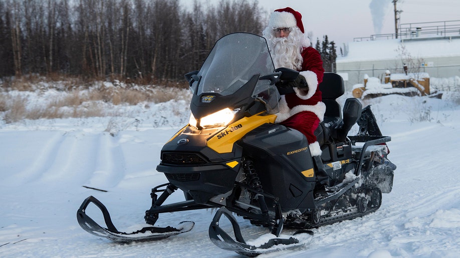 A photo of a Marine Santa on a snowmobile