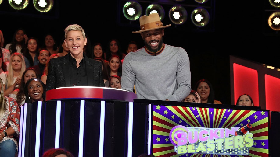 Stephen Boss with a hat net to Ellen DeGeneres