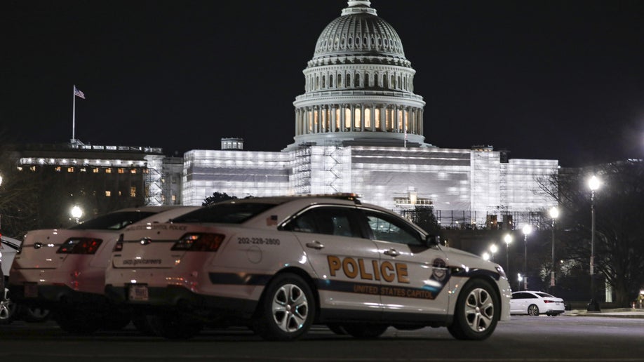 Capitol police cruisers are seen outside the Capitol building