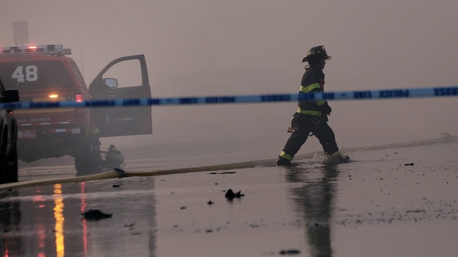 A firefighter and caution tape