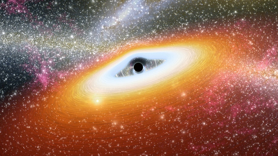 A photo of a black hole with light around it