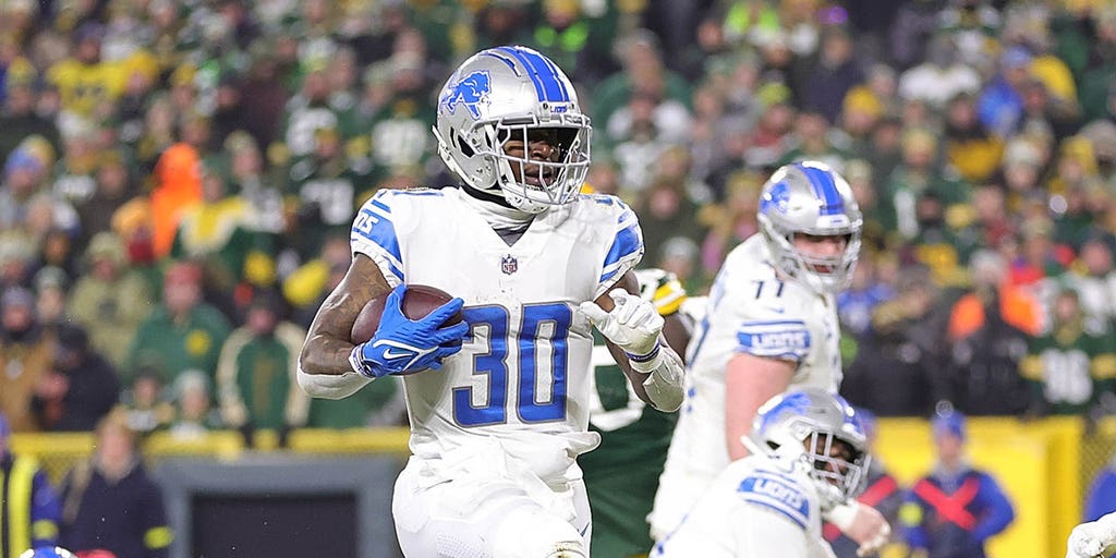 FOXBOROUGH, MA - OCTOBER 09: Detroit Lions running back Jamaal Williams  (30) interacts with fans prior to the NFL game between Detroit Lions and  New England Patriots on October 9, 2022, at