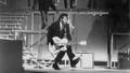 Rock and roll guitarist Chuck Berry performs his 'duck walk' as he plays his electric hollowbody guitar at the TAMI Show on December 29, 1964 at the Santa Monica Civic Auditorium in Santa Monica, California. Other performers included James Brown, The Rolling Stones, The Beatles and Jan &amp;amp; Dean.