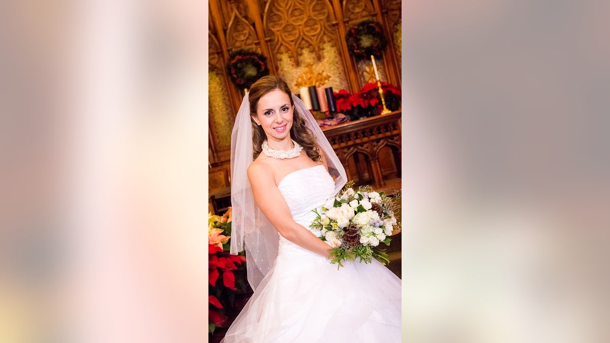 Bride holds floral bouquet in church