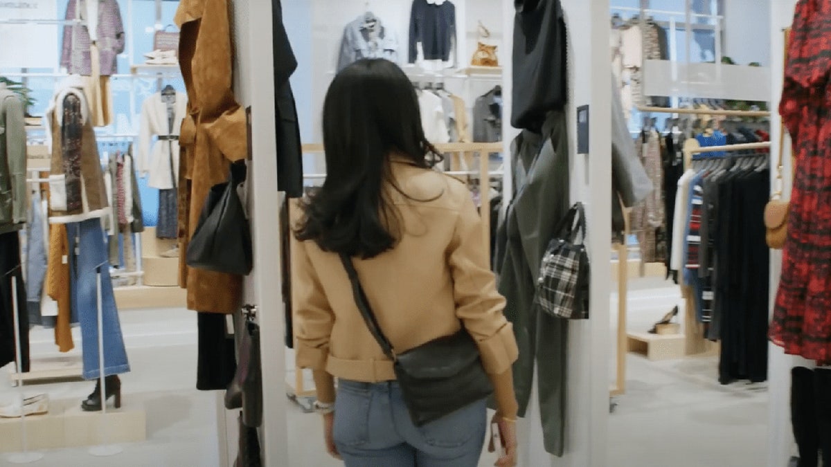 Woman walks around clothing store