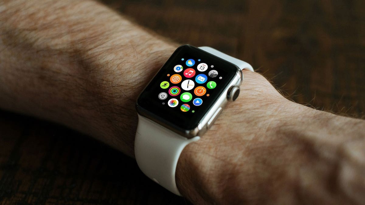 Photo of a man wearing an Apple Watch on his wrist.